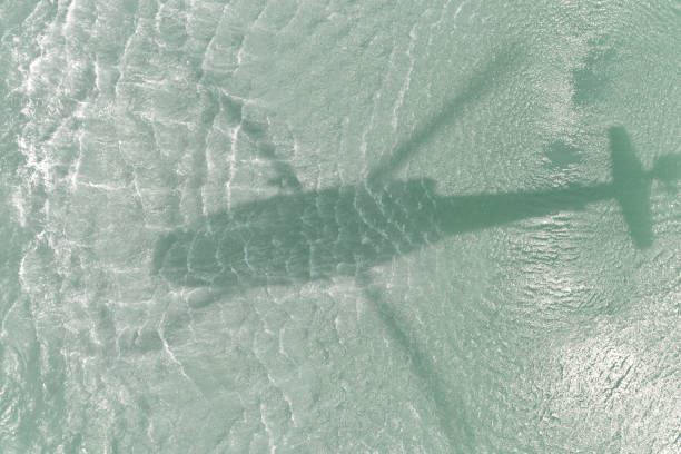 istock Helicopter shadow in the sea 813929658