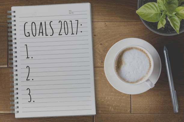 istock View from above on the table with a notebook and goals for 2017 year 813929686