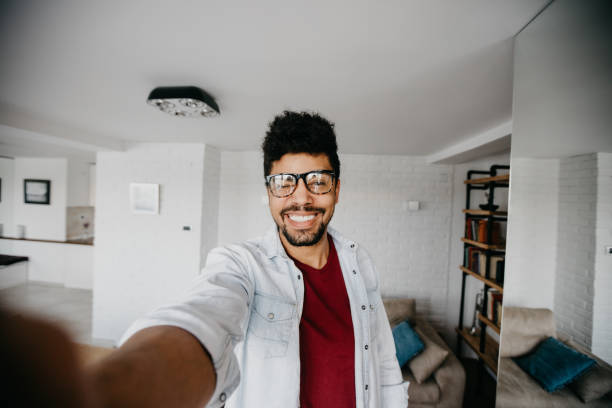 istock Smiling man winks to the camera while he takes selfie 813935296