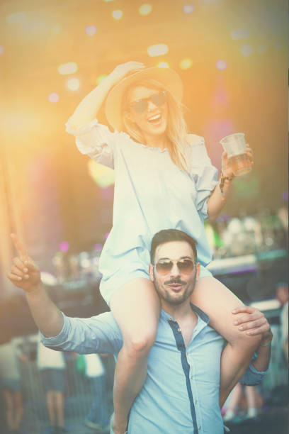 istock Guy holding girl on arms on concert 813962590
