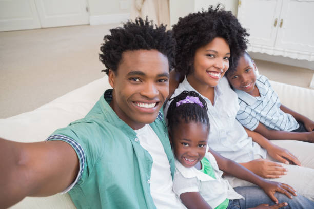 istock Happy family taking a selfie on the couch 813962698