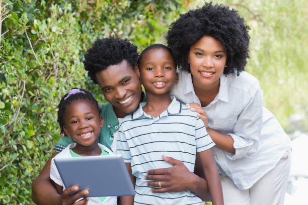 istock Happy family looking at tablet pc 813967288