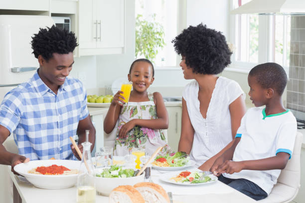 istock Happy family sitting down to dinner together 813970302