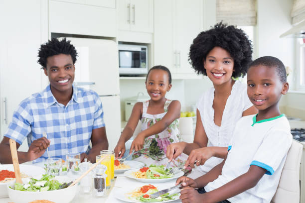 istock Happy family sitting down to dinner together 813972452