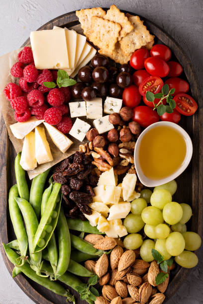 istock Cheese plate with fresh vegetables and fruits 813979704