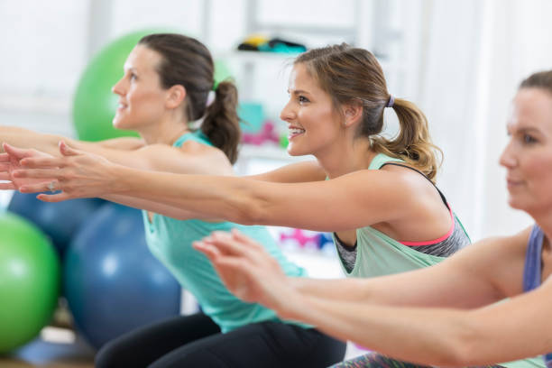 istock Three women are doing squats and working their thighs at the gym 813979844