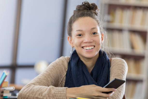 istock Cheerful college student with smart phone 813980186