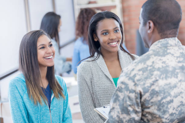 istock Female students talk with recruitment officer 813983648
