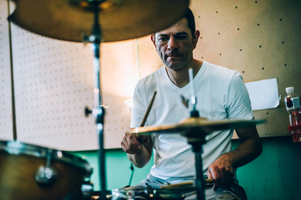 istock Behind scene. Drummer artist musician playing the drums with drumsticks 813987784