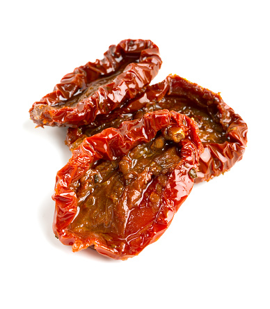 sun dried tomatoes with olive oil isolated on white