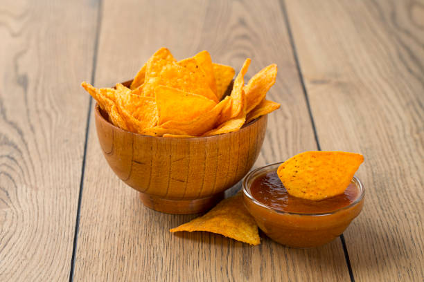 istock tortilla chips in wooden bowl on a desk 813992230