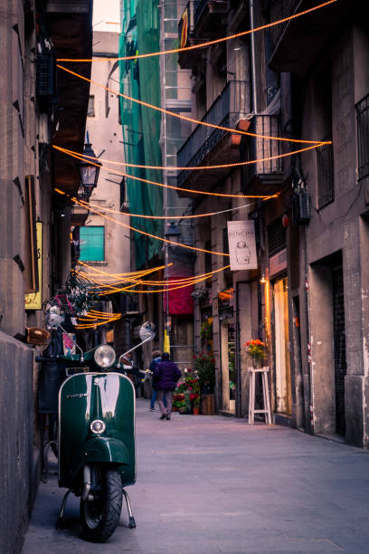 A street in El Born, Barcelona with a Vespa in the foregound.