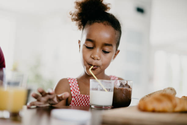 istock Girl drinking milkshake through a straw 813998940