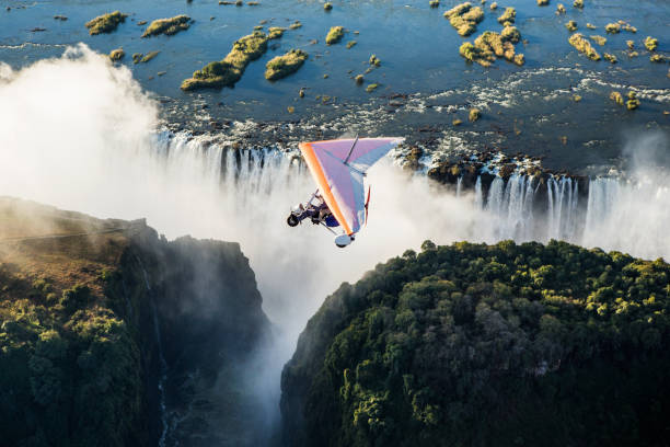 Tourists fly over the Victoria Falls on the trikes. Africa, Zambia, Victoria Falls. July 18, 2014. stock photo