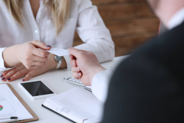 istock Female hand in suit give blank calling card 814002572