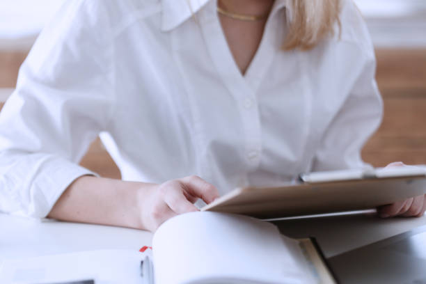 istock Female hands hold clipboard pad with financial statistics 814002616