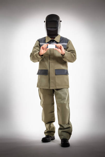 istock Welder in welding helmet and blue protective gloves with white format 814018446