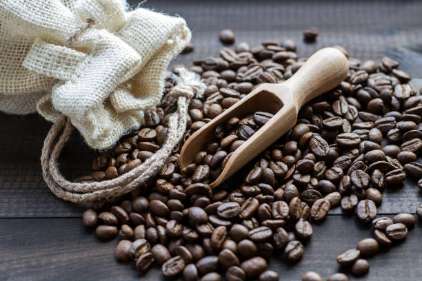 istock burned coffee beans with wooden scoop 814030434