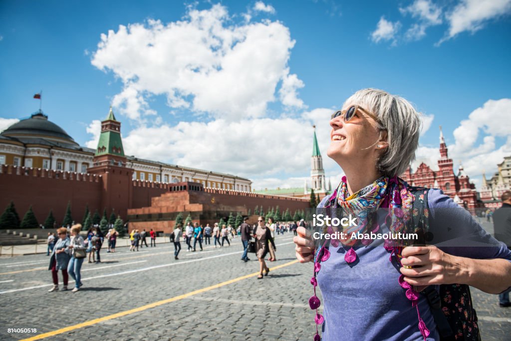 Portrait of a Beautiful Mature Woman Enjoying the  Red Square in Moscow, Russia Portrait of a mature woman enjoying the Red Square in Moscow, Russia.  Nikon D800, full frame, XXXL: Tourist Stock Photo