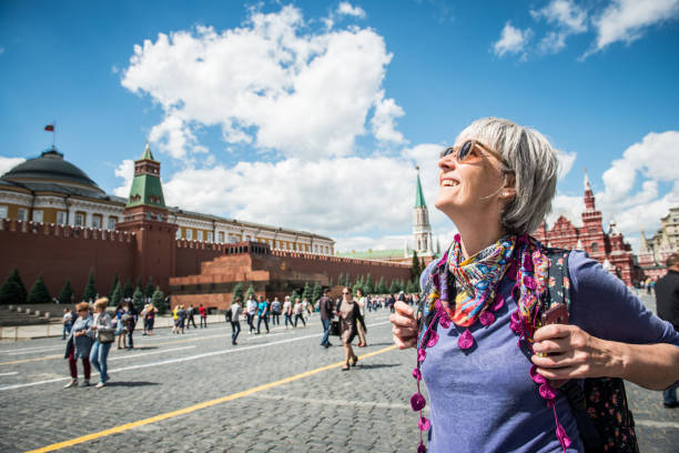 Portrait of a Beautiful Mature Woman Enjoying the  Red Square in Moscow, Russia stock photo