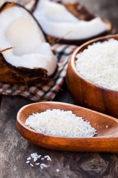 istock Cracked  coconut and flakes on rustic wooden table background 814050818