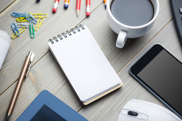 istock Notepad next to the cup of coffee smartphone mouse and tablet 814052862