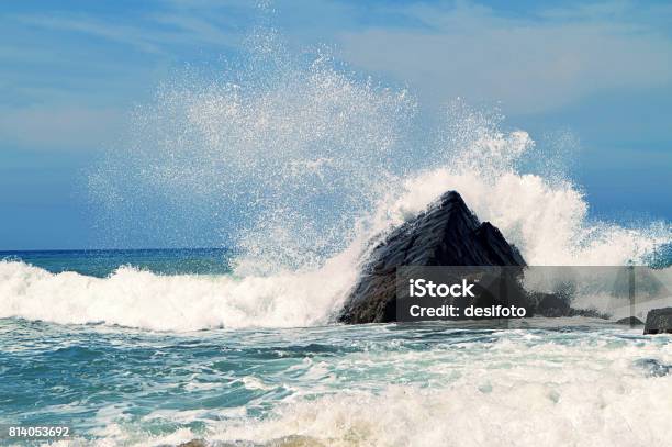 Scenic Water Splash And A Rock In Ocean Stock Photo - Download Image Now - Rock - Object, Breaking Wave, Wave - Water