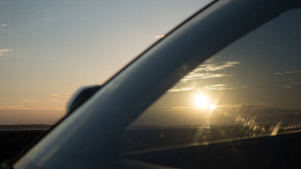 istock Beautiful sunset and sky with clouds through the windshield of the car 814055870