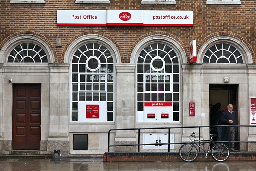 People visit Post Office in London. Royal Mail was founded in 1516 and employs 150,000 people (2013).