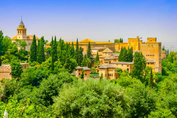 istock View of Ancient Alhambra Fort in Grenada, Spain Through a Forest 814077080