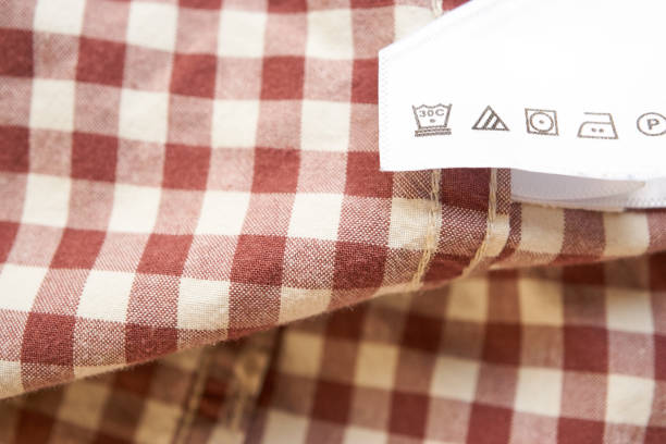 closeup of the bright clothes label brown plaid shirt. manual for lazy man how to care wardrobe