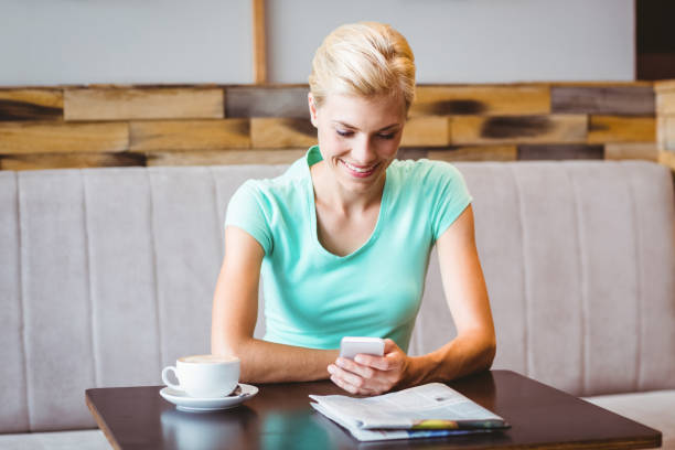 istock Pretty blonde woman using her smartphone 814101420