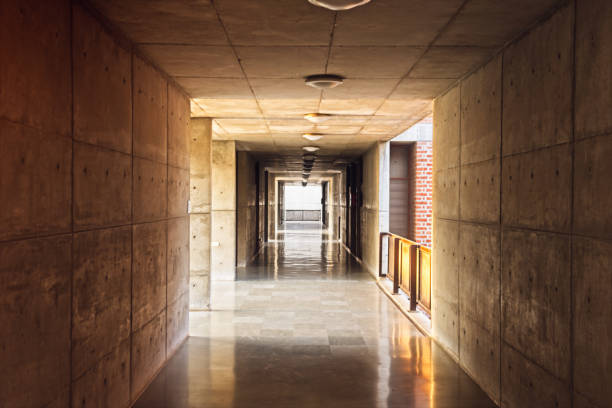 istock A long corridor with concrete walls bathed in sunlight 814101924