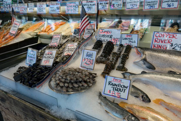 Fresh Seafood Market Stall Fresh seafood stall with Salmon Lobster Prawns Clams Crabs Octopus Oyster at public market in Seattle Washington pike place market stock pictures, royalty-free photos & images