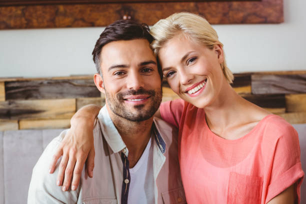 istock Happy couple cuddling on the sofa 814120898