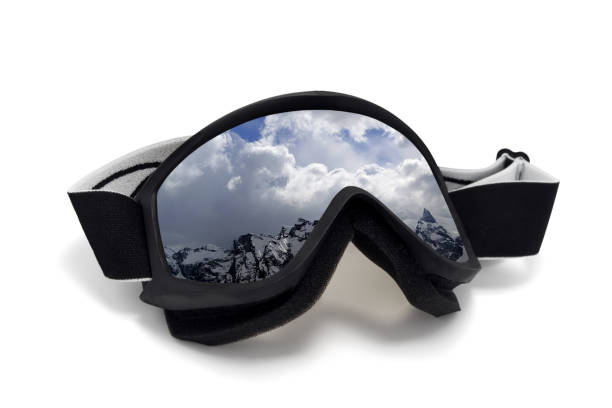 Ski goggles with reflection of winter snow mountains. Isolated on white background