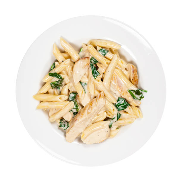 Spinach Chicken Alfredo Parmesan Pasta Chicken Alfredo Pasta with Spinach Isolated on White. Selective focus. penne stock pictures, royalty-free photos & images