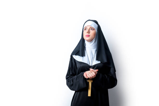 Young serious nun with cross