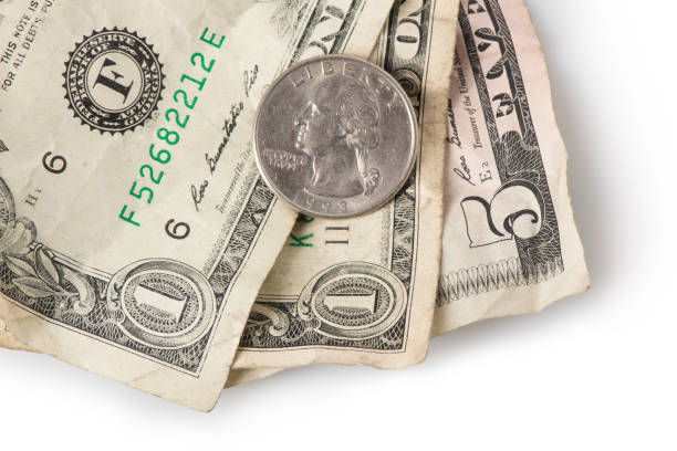 Minimum Wage Wrinkled dollar bills and a quarter adding up to $7.25, the current (as of 2016) U.S. Federal Minimum wage. minimum wage stock pictures, royalty-free photos & images