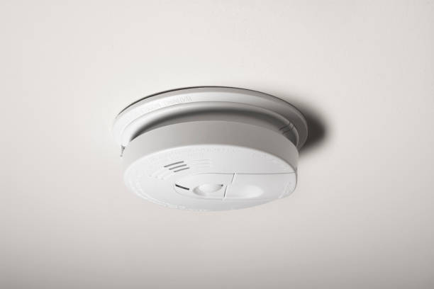 Smoke Detector A smoke detector on the ceiling of a home. smoke detector photos stock pictures, royalty-free photos & images