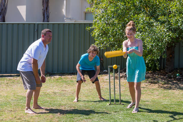 istock Family Playing Backyard Cricket 814150448
