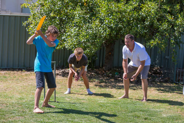 istock Family Playing Backyard Cricket 814150466