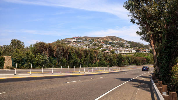 istock Blue sky over Pacific Coast Highway road heading into Laguna Beach 814167442
