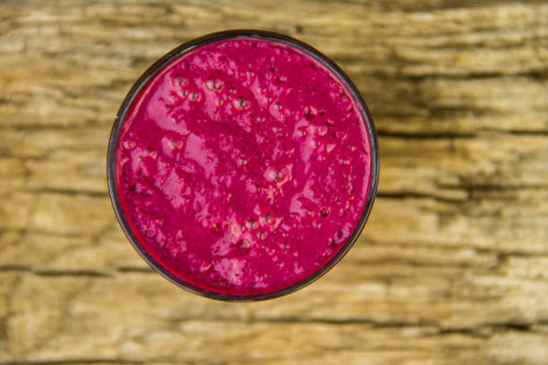 istock Glass of berry smoothie on rustic wooden table 814167912