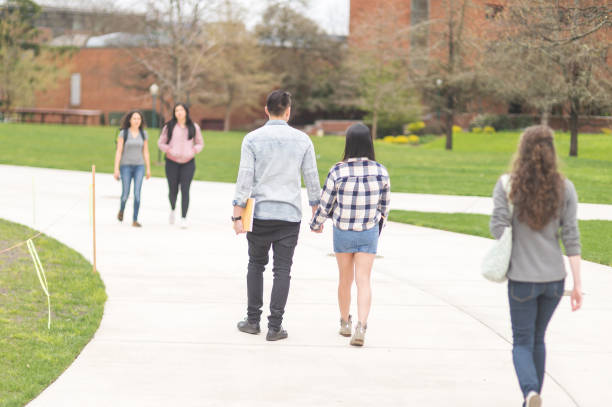 istock Cute young Asian couple walk across college campus 814170728