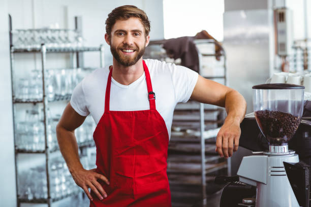 istock Handsome barista smiling at the camera 814184092
