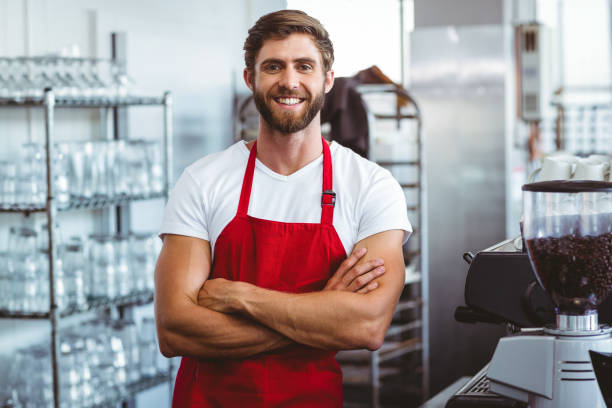 istock Handsome barista smiling at the camera 814184114