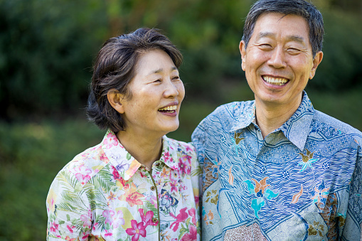 A beautiful Asian senior couple smiling and enjoying life together