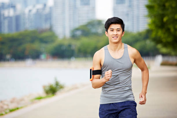 istock young asian adult running in park 814192008