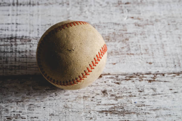 istock old Baseball and glove on wood background with filter effect retro vintage style 814192020